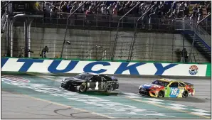  ?? AP/TIMOTHY D. EASLEY ?? Kurt Busch (1) crosses the finish line ahead of his brother Kyle (18) on Saturday to win the NASCAR Cup Series race at Kentucky Speedway in Sparta, Ky.