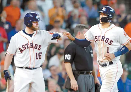  ?? AP-Yonhap ?? Houston Astros Brian McCann, left, congratula­tes Carlos Correa, right, after he scored on a hit by Yuli Gurriel during the fourth inning of a baseball game against the San Francisco Giants in Houston, Wednesday.