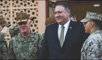  ?? Associated Press ?? POLAND PROTEST — U.S. Secretary of State Mike Pompeo, center walks with Vice Adm. James Malloy, commander of the U.S. Naval Forces Central Command/5th Fleet.