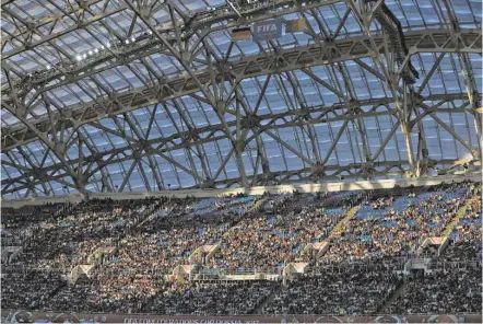  ?? ASSOCIATED PRESS FILE PHOTO ?? Spectators sit in the stands June 25 during the Confederat­ions Cup, Group B soccer match between Germany and Cameroon, at the Fisht Stadium in Sochi, Russia. After years of controvers­y, Russian officials think their World Cup has weathered the storm....