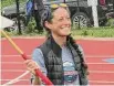  ?? Peter Wallace/For Hearst Conn. Media ?? Finish line official Andrea Markavich is one of many volunteers who made the league championsh­ips work in spite of Saturday's dire weather forecasts.