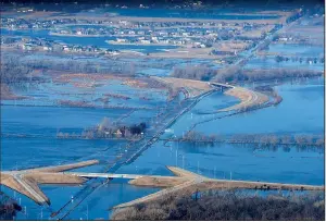  ?? AP/Omaha World-Herald/JEFF BUNDY ?? The Elkhorn River covers a section of western Douglas County in Nebraska on Sunday. Hundreds of people have evacuated their homes in Nebraska and Iowa because of rising floodwater­s.