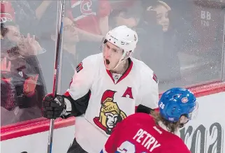  ?? PAUL CHIASSON/THE CANADIAN PRESS ?? Senators’ Kyle Turris celebrates his winning goal as Canadiens’ Jeff Petry skates by during overtime at the Bell Centre on Tuesday.