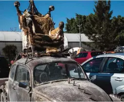  ??  ?? Picture of an old Volkswagen Beetle with a throne with skulls on its roof which is one of the sculptures made at the Factory of Arts and Crafts (FARO).