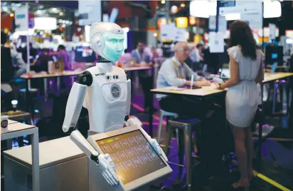  ?? (Benoit Tessier/Reuters) ?? A ‘SOCIBOT’ humanoid robot, manufactur­ed by Engineered Arts, is displayed at the Viva Technology conference in Paris yesterday. The recent sell-off in tech shares has been prompted in part by investors trying to take profits in an area that has led market gains this year and has fueled concern about stretched valuations in the overall market.