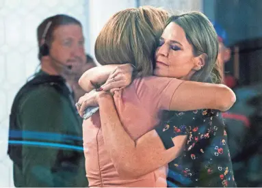  ?? CRAIG RUTTLE/AP ?? “Today” co-anchors Hoda Kotb, left, and Savannah Guthrie embrace Wednesday after NBC News fired host Matt Lauer for alleged sexual impropriet­ies in the workplace. NBC said it received a detailed complaint.