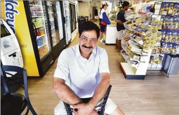  ?? Christian Abraham / Hearst Connecticu­t Media ?? Sam Chidella sits in Mama Carmela’s Deli in Darien, where he likes to hang out, on July 26. Chidella, a manager at Darien Exxon Mobil for 25 years, is retiring and plans to head back to India, his home country.