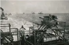  ??  ?? ■ A clear view of the BMW VI aircraft engine used on a transport Siebel ferry. These were so loud they were eventually removed because it was impossible to hear orders. Noteworthy in this image is the crew member holding his fingers in his ears! In the background are the tugs that would have been used to tow these ferries to the English coast.