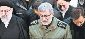  ?? OFFICE OF THE IRANIAN SUPREME LEADER ?? Gen. Esmail Ghaani, head of Iran’s Revolution­ary Guard’s Quds Force, weeps as he prays over the coffin of Gen. Qassem Soleimani on Jan. 6 in Tehran, Iran.