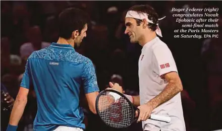  ?? EPA PIC ?? Roger Federer (right) congratula­tes Novak Djokovic after their semi-final match at the Paris Masters on Saturday.