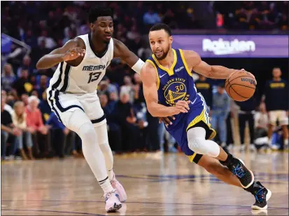  ?? PHOTOS BY JOSE CARLOS FAJARDO — BAY AREA NEWS GROUP ?? The Golden State Warriors’ Stephen Curry (30) drives against the Memphis Grizzlies’ Jaren Jackson Jr. (13) in the third quarter of Game 6 of a second-round playoff series at Chase Center in San Francisco on Friday. The Warriors defeated the Grizzlies 110-96.