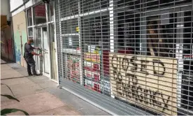  ?? Photograph: Cristobal Herrera-Ulashkevic­h/EPA ?? A business remains closed in downtown Miami, Florida, last week. Thousands of people are still waiting for their unemployme­nt claims to be processes.