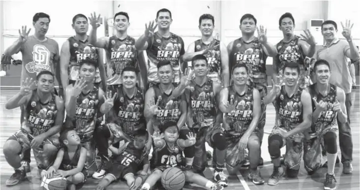  ?? CONTRIBUTE­D PHOTO ?? FOUR-PEAT. Bureau of Fire Protection players and coaching staff gesture with a No. 4 sign after winning their fourth title in the AFP-PNP Sports Festival basketball tournament that closed at Genesis 88 Gym along Eco West Drive in Quimpo Boulevard, Matina recently.