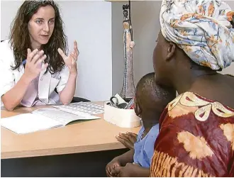  ?? Elizabeth Bryant / Religion News Service ?? Midwife Mathilde Delespine speaks with a Malian woman at a new women’s center outside Paris.