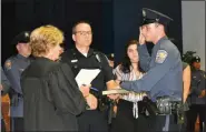  ?? PHOTO COURTESY OF UPPER GWYNEDD POLICE DEPARTMENT ?? New Upper Gwynedd Police Officer Ryan Sloan, right, receives his oath from District Judge Suzan Leonard during a police promotion ceremony on July 22.