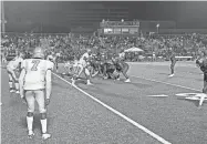  ?? MARK GIANNOTTO/THE COMMERCIAL APPEAL PHOTOS BY ?? White Station QB Braylen Ragland prepares to take a snap in the Spartans' season-opening win over Melrose at Crump Stadium on Saturday.