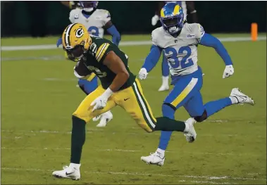  ?? MORRY GASH — THE ASSOCIATED PRESS ?? The Green Bay Packers’ Allen Lazard breaks away from the Los Angeles Rams’ Jordan Fuller (32) to score on a 58yard touchdown run during the second half of an NFC divisional playoff game Saturday in Green Bay, Wis. The Packers won 32-18.