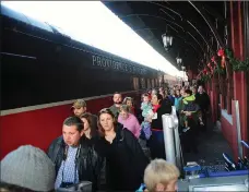  ?? File photo by Ernest A. Brown ?? Visitors line up to board the popular Polar Express train ride from Depot Square in Woonsocket during the holiday season.