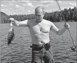  ?? [ALEXEI NIKOLSKY/SPUTNIK] ?? Russian President Vladimir Putin holds a fish he caught during a minivacati­on in Siberia’s Tyva region.