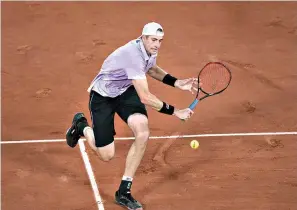  ?? AP Photo/Christophe Ena ?? ■ John Isner plays a return to Stefanos Tsitsipas during their third-round match Friday at the French Open in Paris.