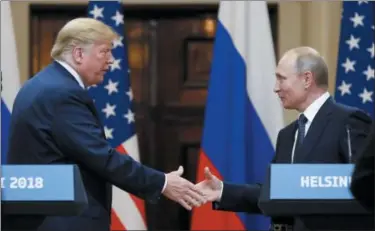  ?? ALEXANDER ZEMLIANICH­ENKO — THE ASSOCIATED PRESS ?? U.S. President Donald Trump shakes hand with Russian President Vladimir Putin at the end of the press conference after their meeting at the Presidenti­al Palace in Helsinki, Finland, Monday.