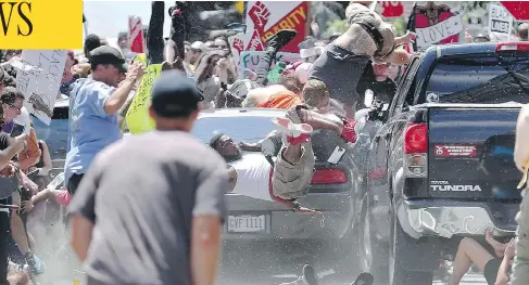  ?? RYAN M. KELLY/THE DAILY PROGRESS VIA AP ?? People fly into the air as a car drives into a group of protesters demonstrat­ing against a white nationalis­t rally in Charlottes­ville, Va., Saturday. Far-right extremists were holding the rally to protest plans by the city of Charlottes­ville to remove...