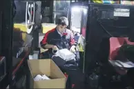  ??  ?? A worker sorts parcels at a center in Beijing.