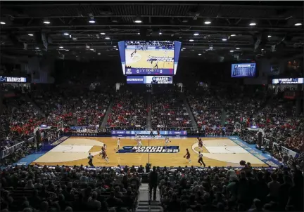  ?? JOHN MINCHILLO - THE ASSOCIATED PRESS ?? In this March 19, 2019, file photo, spectators watch from the stands during the first half of a First Four game of the NCAA college basketball tournament between Temple and Belmont, in Dayton, Ohio.