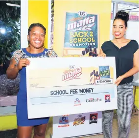  ?? CONTRIBUTE­D ?? Omeal Houston (left), winner of $50,000 in the Malta Back-to-School Scratch and Win competitio­n, excitingly collects her cheque from Ellisse Campbell, assistant brand manager of stouts and Malta at Red Stripe.