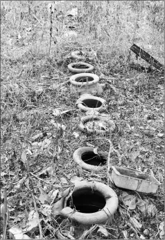  ??  ?? The nine half buried jars in front of several graves in Kerto.