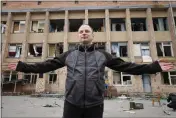  ?? EFREM LUKATSKY — THE ASSOCIATED PRESS ?? Maxim Shevchuk, the deputy head of the state agency managing the Chernobyl exclusion zone, talks near a building looted by Russian troops adjacent to the nuclear power plant near Chernobyl, Ukraine, on Saturday.