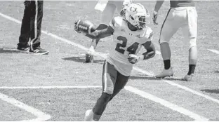  ?? TIM BROGDON/MIAMI ATHLETICS ?? Hurricanes freshman safety Kamren Kinchens after intercepti­ng a pass in UM’s spring game Saturday at Hard Rock Stadium.