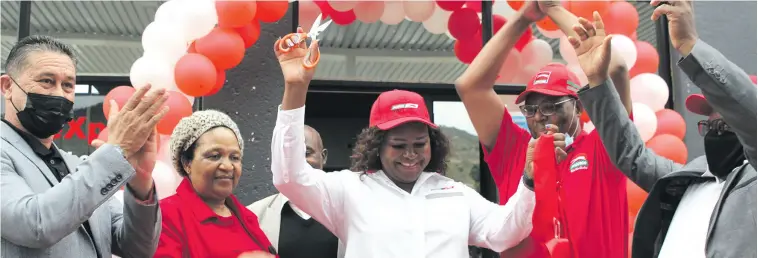  ?? ?? Martha Makhubedu (middle), the owner and manager of Puma’s new filling station in Clau-Clau, celebrates with family and colleagues after the ribbon cutting. > Photo: Andrea van Wyk