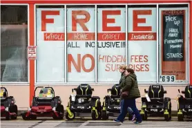  ?? GJP/Associated Press ?? Lawnmowers are displayed outside a Home Depot store in Uniontown, Pa. Americans’ outlook on the economy was down slightly this month.