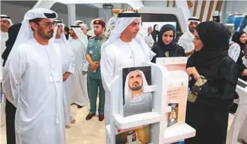  ?? Ahmed Kutty/Gulf News ?? Above: Shaikh Saif tours the event after opening the Aqdar World Summit in Abu Dhabi yesterday. Left: Dr Ali Rashid Al Nuaimi receives a memento from Hussain Ebrahim Al Hammadi, Minister of Education, during the Aqdar World Summit.