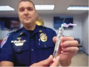  ?? EDDIE MOORE/JOURNAL ?? Santa Fe Police Capt. Anthony Tapia holds a blood test kit that would be used to test if a driver is intoxicate­d. The officer would administer the test, but the blood would be drawn by a nurse, physician or someone qualified to draw blood.