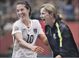  ?? Andy Clark AFP/Getty Images ?? CARLI LOYD, left, celebrates with coach Jill Ellis after the U.S. team’s World Cup victory in 2015. The U.S. is 11-0-2 this year and is unbeaten in its last 21 games.