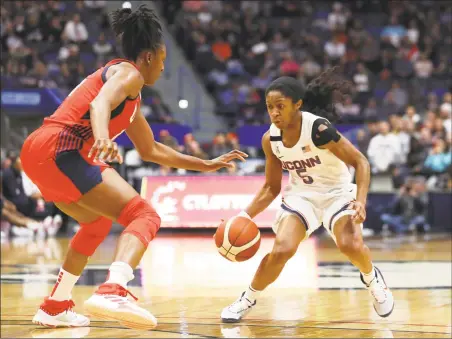  ?? Maddie Meyer / Getty Images ?? UConn’s Crystal Dangerfiel­d (5) is defended by Team USA’s Nneka Ogwumike during Monday’s exhibition game in Hartford.