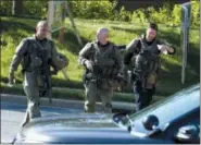  ?? JOSE LUIS MAGANA - THE ASSOCIATED PRESS ?? Police officers walk at the scene after multiple people were shot at a newspaper’s office building in Annapolis, Md., Thursday. A single shooter killed several people Thursday and wounded others at a newspaper in Annapolis, Maryland, and police said a...