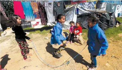  ?? (Reuters) ?? SYRIAN REFUGEE children play at a tented settlement in the town of Qab Elias, in Lebanon’s Bekaa Valley, on March 13.