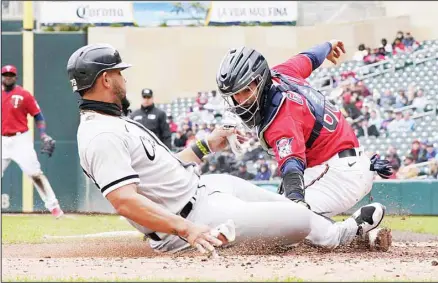  ?? ?? Chicago White Sox’s Jose Abreu (left), is tagged out by Minnesota Twins catcher Jose Godoy while trying to score on a hit by Andrew Vaughn in the third inning of a baseball game, on April 24, in Minneapoli­s. (AP)