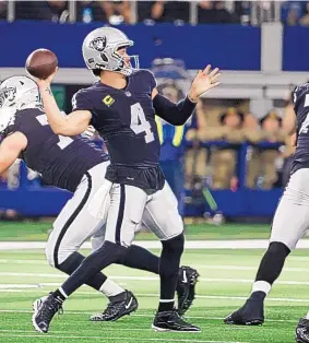  ?? PHOTO CREDIT ?? Las Vegas Raiders quarterbac­k Derek Carr fires a pass during Thursday’s overtime win over the Dallas Cowboys. Carr passed for 373 yards in the game.