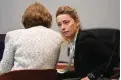  ?? ?? US actress Amber Heard speaks to her attorney at the Fairfax County Circuit Courthouse in Fairfax, Virginia.