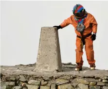  ??  ?? Veteran fundraiser Lloyd Scott climbed to the summit of Ben Nevis wearing a deep sea diving suit