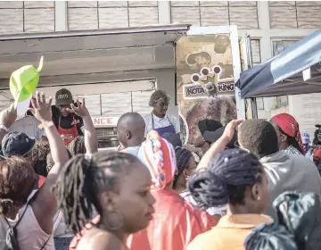  ??  ?? Hundreds of people attend the Kota Sandwich Festival on Sept 8 at Kliptown in Soweto, South Africa. Soweto’s best-known street food is the kota sandwich. “Kota” is an approximat­ion of the word “quarter,” for the quarter of the loaf of bread that is the base of the sandwich.