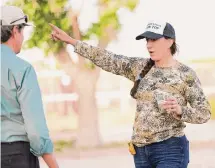  ?? Elizabeth Conley/Staff photograph­er ?? Attorney Sarah Stogner talks to a visitor to Antina Ranch in West Texas. Stogner will run against Railroad Commission­er Christi Craddick next year as a member of the Forward Party.