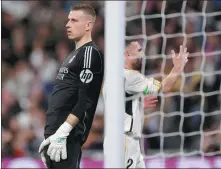  ?? AFP ?? Real Madrid keeper Andriy Lunin (left) and defender Dani Carvajal react to Atletico Madrid’s late equalizer, scored by Marcos Llorente during a Spanish league match at the Santiago Bernabeu stadium in Madrid on Sunday.