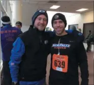  ?? GLENN GRIFFITH — TROY RECORD ?? Zach Makarewicz and Kevin Makarewicz, left and right, prepare for the 10K Turkey Trot in Troy Thursday.