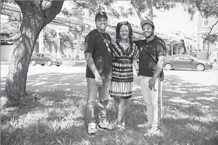  ?? ERIN HOOLEY/CHICAGO TRIBUNE ?? Emily Hooper Lansana and her two sons — Onam, 20, left, and Nile, 22 — each wrote stanzas for “American Gun: A Poem by 100 Chicagoans.”