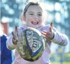  ??  ?? Pass it on . . . Charlotte Crosbie (7), of Clyde, enjoys herself while waiting for her cousin’s team to kick off again.